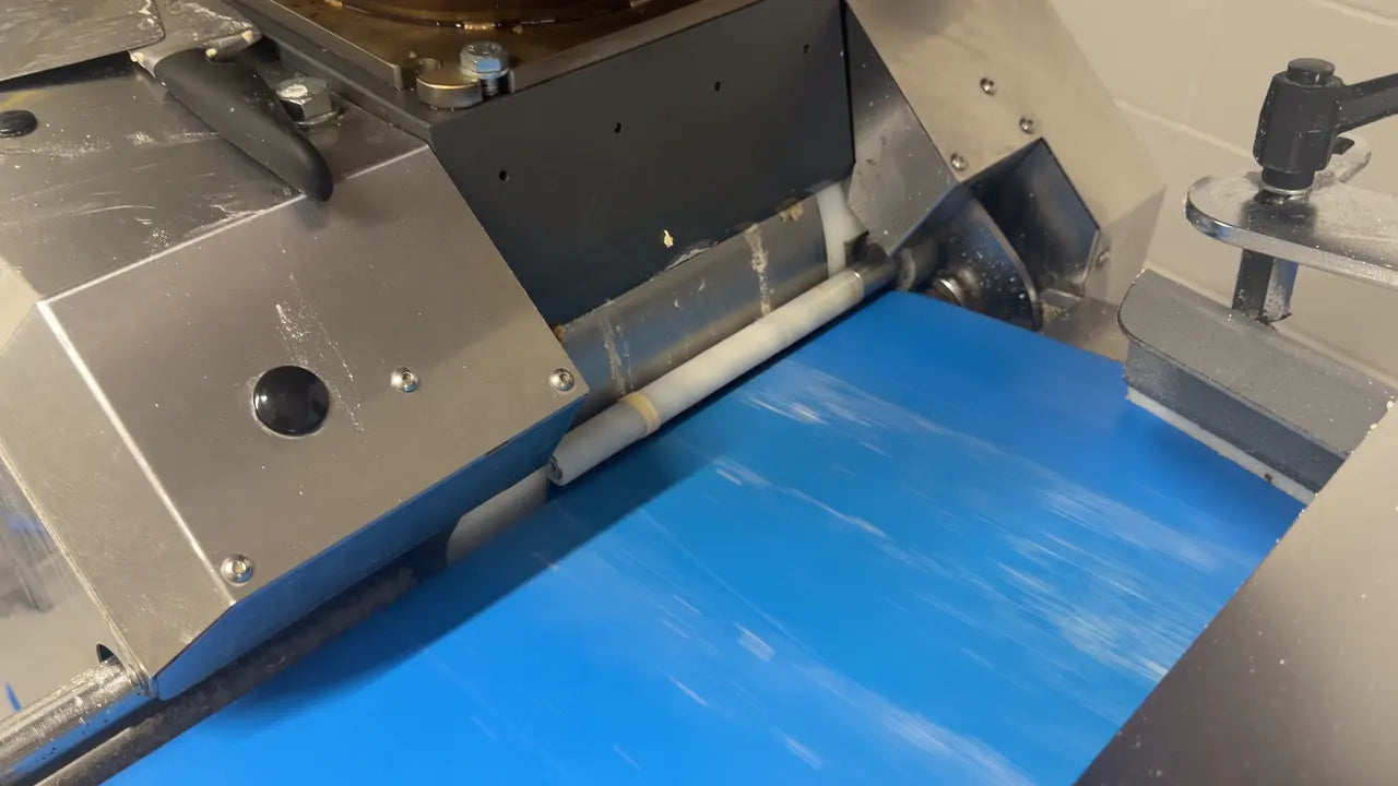 Dough moving onto a conveyor in the Great Balls of Flour bakery
