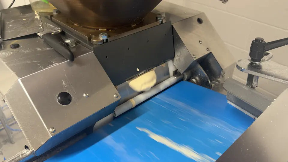 Dough portions moving from the machine onto a conveyor