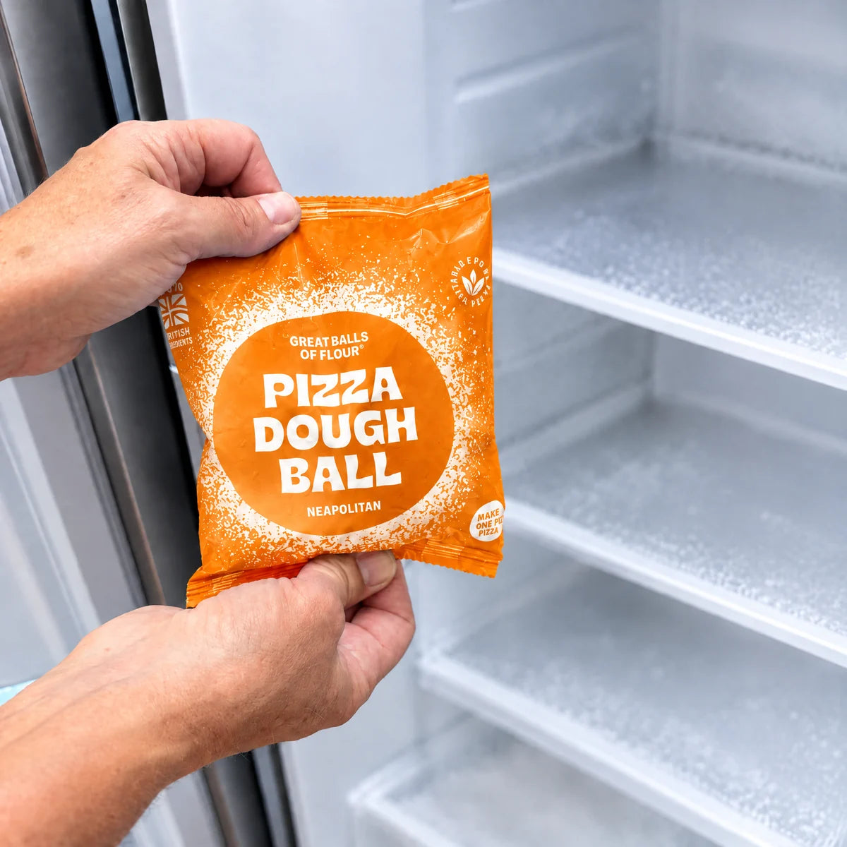Original Neapolitan pizza dough pack held in front of a freezer