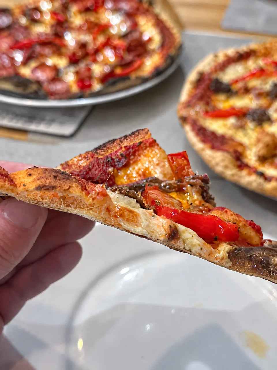 A thin, crisp Romana Tonda pizza slice made at home